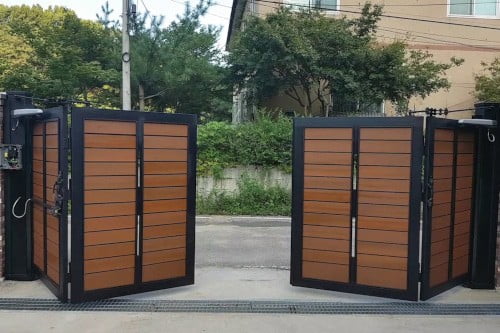 An automated bi-folding gate in a residential area