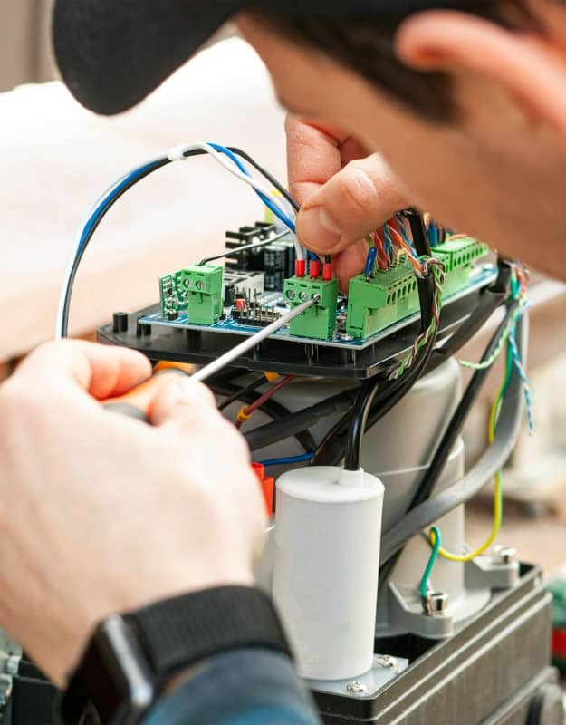 A Gate Gurus technician inspecting an automatic gate opener