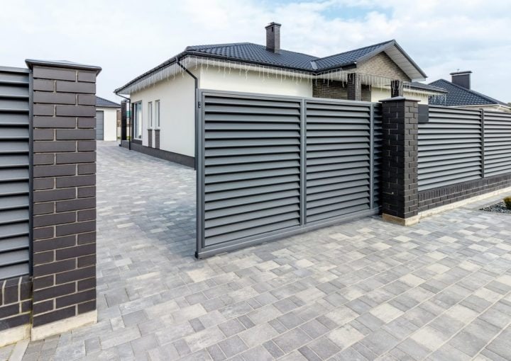 Slate grey automatic gate opening on driveway